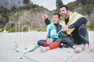 Look at that wave, Dad. a young boy out surfing with his father.