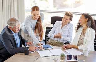 I thought the client would approve of some humour. Shot of a diverse group of businesspeople having a discussion in the office.