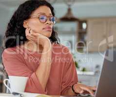 Do your research well before you commit to any insurance plans. Shot of a young woman working on a laptop at home.