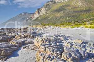 Landscape of boulders and mountains on rocky beach in Cape Town, South Africa. Empty beach during a summer day on a weekend outside with copyspace. Enjoying holiday and vacation overseas and abroad