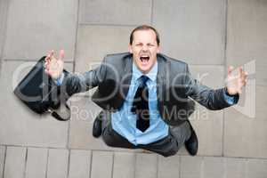 When will I catch a break. Shot of a businessman shouting at the sky in frustration.