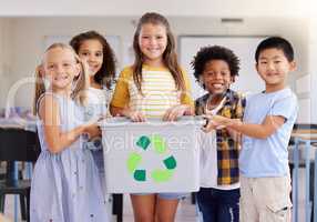 Young children are naturally curious and observant. Shot of a group of preschoolers holding a recycling bin in class.