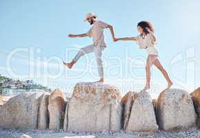 Take a chance on love. a young couple spending time together at the beach.