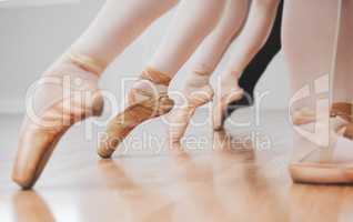 Ballet is incredible to watch. Shot of a group of ballerinas with toes pointed.