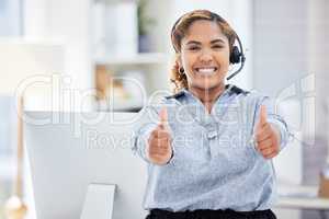 It support agent giving the thumbs up. Businesswoman working in customer service celebrating her success. Call center worker gesturing with the thumbs up. Portrait of happy helpdesk worker