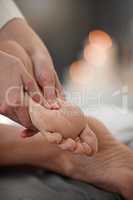 Bringing bliss to her clients. a masseuse giving a client a facial massage.