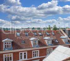 Oldwindow. Rooftop view of buildings in a town with glass windows and frames under a cloudy blue sky. Beautiful landscape architecture with clouds surrounding a suburban urban environment.