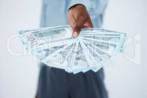 Close up of business womans hands holding banknotes fanned out. Woman offering to give a stack of money for business opportunity or to invest against studio background. Successful and profitable business
