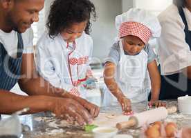 Baking is a brilliant way to bond and make new memories. a couple baking at home with their two children.