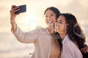 Happiness is a selfie with your bestie. two beautiful young women taking a selfie together outside.