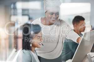 African american call centre telemarketing agent training new mixed race assistant on a computer in an office. Team leader and supervisor troubleshooting solution with intern for customer service and sales support. Colleagues operating helpdesk together