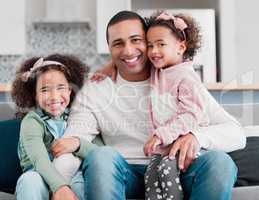 My greatest treasure will always be my family. Portrait of a father bonding with his two little daughters at home.