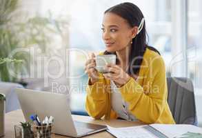 Coffee gives me motivation. a young businesswoman drinking coffee in a modern office at work.