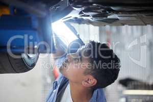 When last was this oil changed. a handsome young male mechanic working on the engine of a car during a service.
