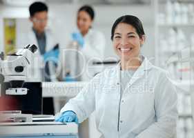 Shes the expert in her field. Shot of a confident young female scientist in her lab.
