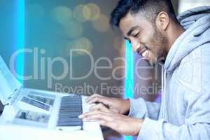 Providing an evening of the best entertainment. a young man playing a piano during an event at night.