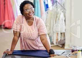 Sewing things is what I do. Cropped portrait of an attractive young seamstress working in her boutique.