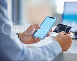 Closeup of one businessman spending money online with a credit card and phone in an office. Making purchase transaction with secure banking payment. Budgeting finance for bills and e-commerce shopping