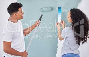 We just love a DIY project. Shot of a young couple looking at a color swatch while busy renovating a house.