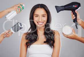 Getting all dolled up. Cropped portrait of an attractive young woman getting done backstage against a grey background.