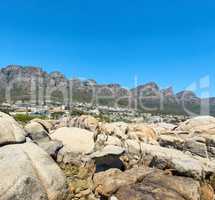 Twelve Apostles at Table Mountain in Cape Town against a clear blue sky background on a sunny day with copy space. View of a peaceful suburb surrounded by scenic mountain landscape and beach boulders