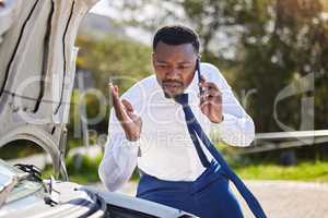 Im going to be late for my meeting. Cropped shot of a handsome businessman on the phone with roadside assistance after suffering a vehicle breakdown.