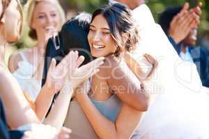 Beautiful stylish bride greeting and socialising with friends and family. Guests congratulating the bride on her wedding day