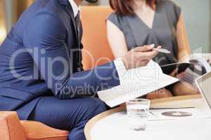 Group of diverse business people with notepads having a meeting in their office. Group of diverse business people with notepads having a meeting in their office.