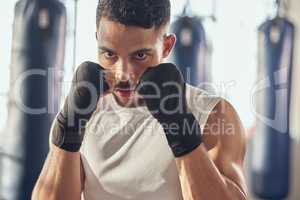 Portrait of boxer ready for combat training. Closeup on face of combat trainer ready for exercise. Boxer ready to throw a punch. Strong boxer punching in the gym. Bodybuilder training