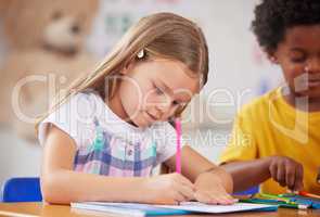 Our days are filled with learning activities. Shot of a preschooler colouring in class.