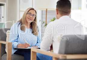 When did you start feeling this way. a mature psychiatrist sitting with her patient during a consultation in her clinic.