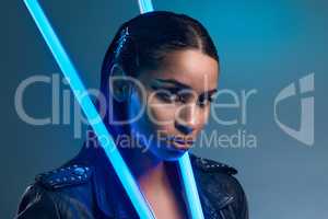 Ready for the future. Conceptual portrait of a stylish young woman posing in studio against a blue background.