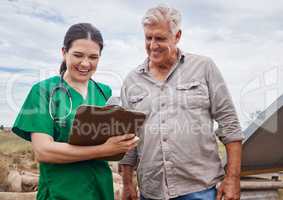 Vets can help farmers to improve fertility. a veterinarian talking to a mature man on his farm.