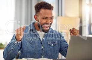 Excited businessman working from home on his laptop cheering. Young businessman doing virtual remote work from home. Entrepreneur cheering after his luck with work. Freelance worker at home