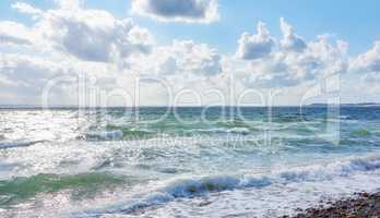 Coast of Kattegat - Helgenaes, Denmark. Ocean waves washing onto empty beach shore. Calm peaceful paradise of summer seascape and sky for relaxing fun holiday abroad or travel vacation overseas