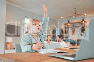 Home schooling girl with her hand in the air. Cute caucasian child using a laptop to attend classes remotely. Asking and answering questions in class. Distance learning is easy with modern technology