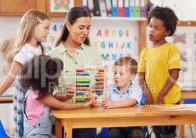 Preschool provides a foundation for learning both socially and academically. Shot of a young woman teaching a class of preschool children.