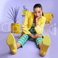 I needed some colour in my life. Full length studio portrait of an attractive young woman dressed in funky attire against a purple background.