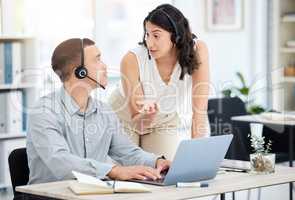 Ill show you a few shortcuts that can really help. two call centre agents working together on a laptop in an office.