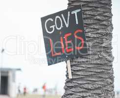 The solution to our wealth disparity is not an announcement. Cape Town, South African - October 2, 2021 A sign on a tree, protesting against government corruption.