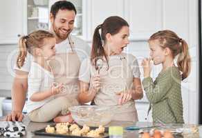 Baking done with care is an act of love. Shot of a family baking together in the kitchen.