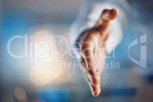 Closeup hand of african man gesturing for a handshake. African american business man standing with his hand out while working late night in office. Making a deal, agreement, merger or partnership