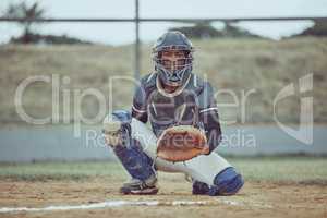 Portrait african american pitcher ready to make a catch with a mitt on a baseball field. Young sportsman in a helmet ready for the ball. Black man athlete playing a game or match on pitch outdoors