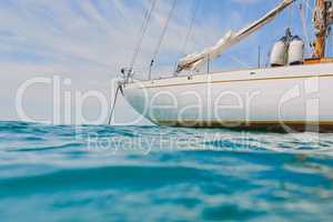 Empty boat docked on the ocean in open water. Boat anchored in the ocean on a sunny day after a sailing cruise.