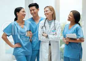 Start the day with a chuckle. Shot of a group of medical practitioners having a discussion in a hospital.