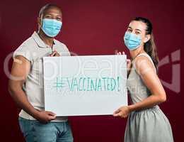 Covid vaccinated African american man and mixed race woman showing and holding poster. Two people wearing surgical face mask isolated on red studio background with copyspace. Promote corona vaccine