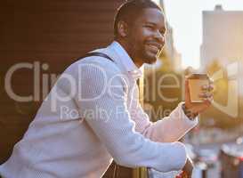 Be appreciative, optimistic and positive about life. a young businessman drinking coffee while standing on the balcony of an office.