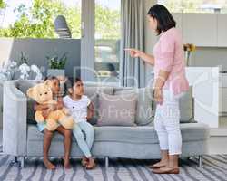 Sometimes tough love is necessary. a young woman scolding her daughters.