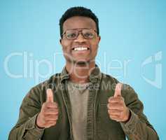 I have faith in you. Shot of a man showing thumbs up while posing against a blue background.