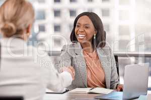 Were assembling a team of enterprising women. Shot of a young businesswoman shaking hands with a fellow staff member.